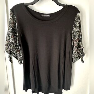 Women’s black top with floral sleeves